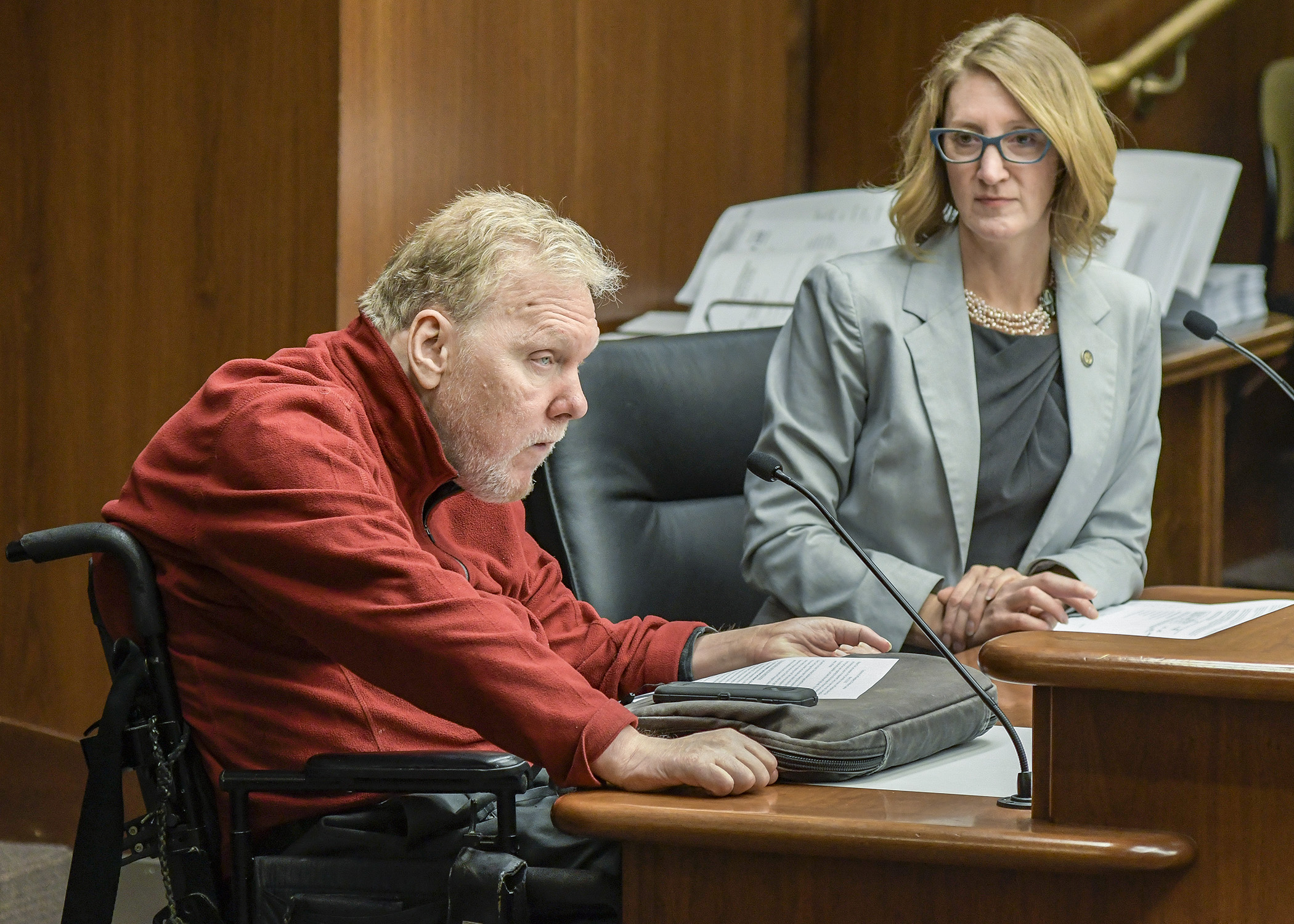 Jeff Bangsberg, board chair for Metropolitan Center for Independent Living, testifies in support of a bill sponsored by Rep. Jennifer Schultz, right, to establish a payment rate methodology for personal care assistance services. Photo by Andrew VonBank